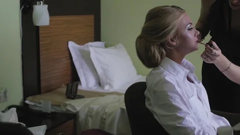 Bride doing makeup before the wedding. a young woman takes a stylist Stock-Footage 81835715