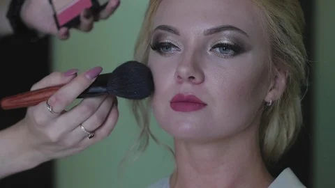 Bride doing makeup before the wedding. a young woman takes a stylist Video stock 81836004