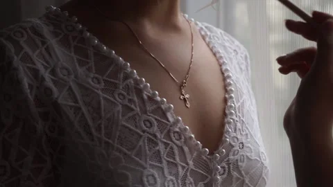 The bride in a dress is standing at the window Stock Footage 159897690