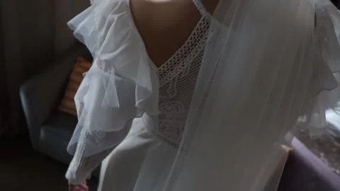 The bride in the dress stands by the window Stock Footage 159882433