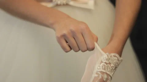 The bride dressing  gloves  before the wedding. Video stock 35587591