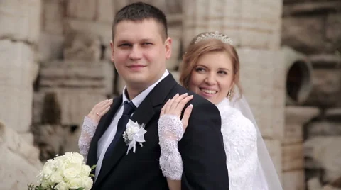 Bride embraces groom's Stock Footage 62430457