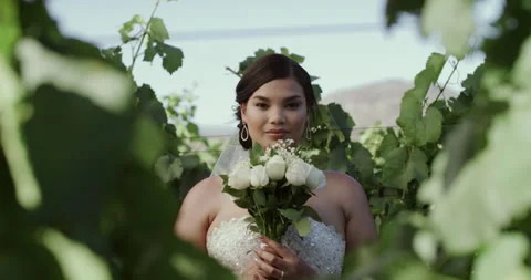Bride, face and wedding with flowers in garden for marriage, commitment and 動画素材 258562894
