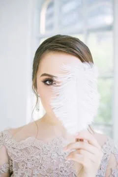 Bride with feathers in hand Stock Photos