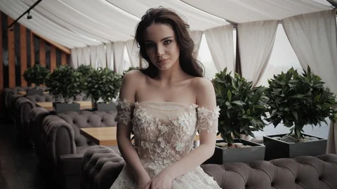 Bride with festive makeup poses in white dress slow motion Video stock 108606460