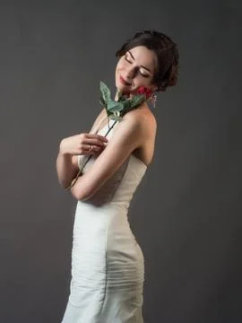 Bride with a flower. Beautiful woman with red roses Stock Photos