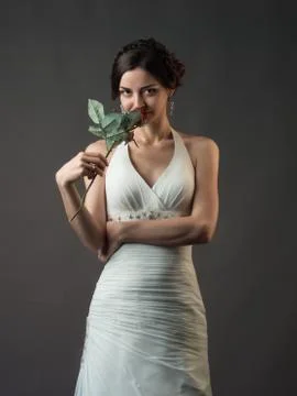 Bride with a flower. Beautiful woman with red roses Stock Photos