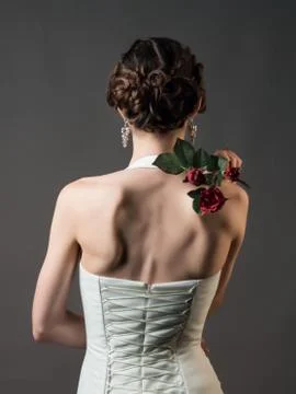 Bride with a flower. Beautiful woman with red roses Stock Photos