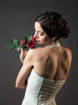 Bride with a flower. Beautiful woman with red roses Stock Photos