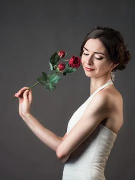 Bride with a flower. Beautiful woman with red roses Stock Photos