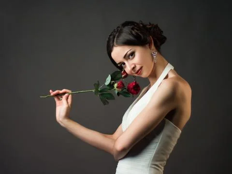 Bride with a flower. Beautiful woman with red roses Stock Photos
