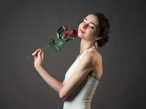 Bride with a flower. Beautiful woman with red roses Stock Photos
