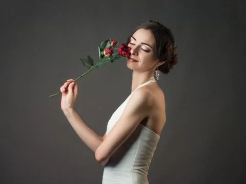 Bride with a flower. Beautiful woman with red roses Stock Photos