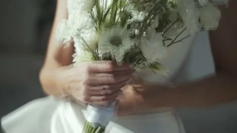 Bride with flowers shows her ring, close-up Stock Footage 220534230