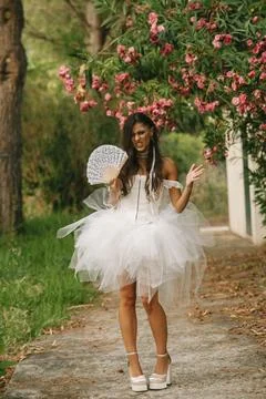 Bride Gestures With Fan On Garden Path Stock Photos