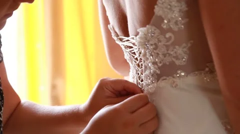 Bride getting ready. beautiful bride in white wedding dress with hairstyle and Stock Footage 52717346