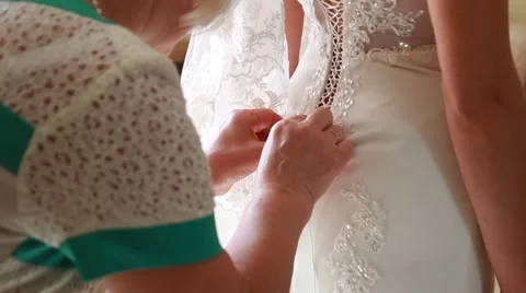 Bride getting ready. beautiful bride in white wedding dress with hairstyle and Видео 52717385