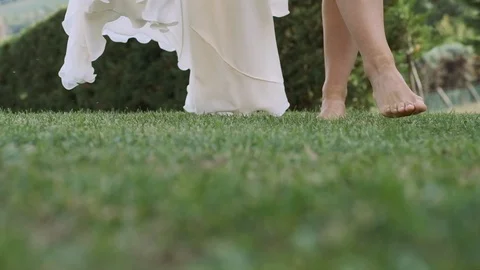 Bride Goes Barefoot On The Grass. Vídeos de archivo 111146167