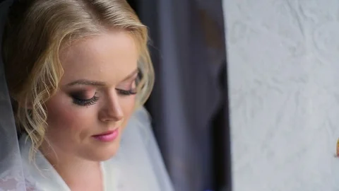 The bride goes to the window and pushed the curtain Stock Footage 83012041