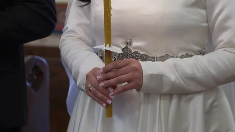 Bride Grips Candle Softly In Ceremony, Ceremony Moment Where Bride Clasps Candle Stock Footage 323775729