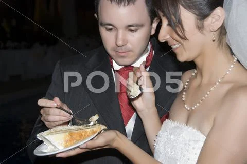 Bride & Groom Eating Wedding Cake