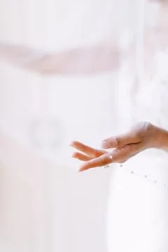 Bride hand holding delicate wedding veil Stock Photos