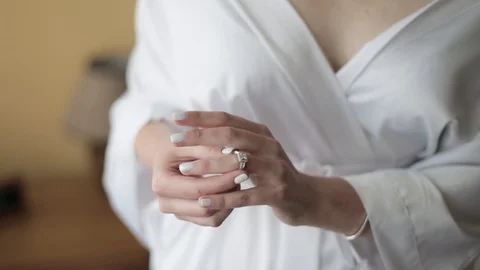 Bride hand putting wedding ring on her finger. wedding ring with stone. slow Stock Footage 128914744