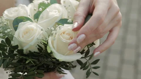 Bride hand touching the wedding bouquet. Close-up. Stock Footage 122998657