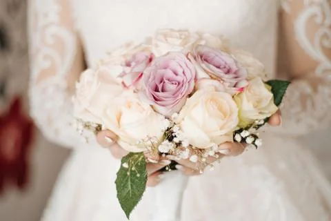 Bride hands holding beautiful bridal bouquet Stock Photos