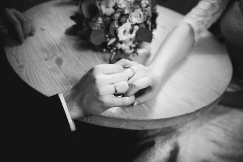 Bride hands with ring and wedding bouquet of flowers Stock Photos