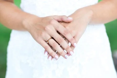 Bride hands with wedding ring on wedding dress 스톡 사진