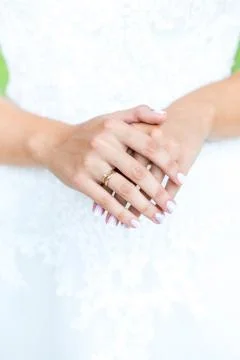 Bride hands with wedding ring on wedding dress Stock Photos