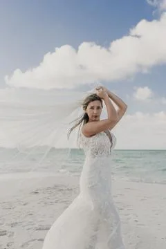 Bride with her veil in the middle of a desert island Stock Photos