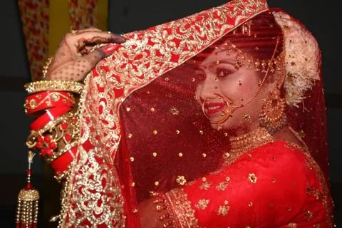 The bride hiding the face with the lap front of the camera Stock Photos