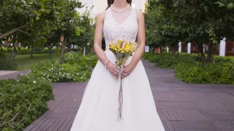 The bride is holding a flower 스톡 동영상 141531246
