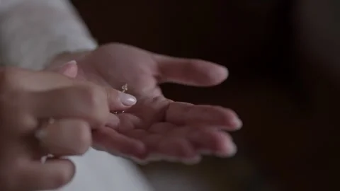 Bride Holding Gold Earrings in Open Palm Close Up Stock Footage 342762617