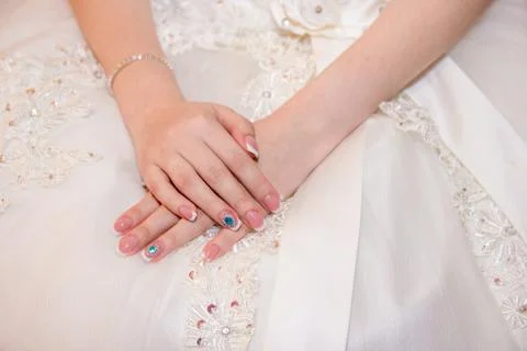 Bride holding hands in front of the dress Stock Photos