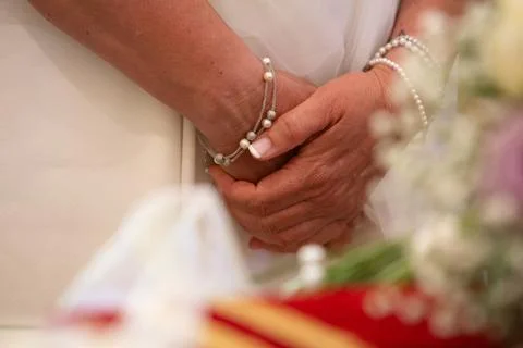 Bride holding her hands together, nervous on her wedding day Photos