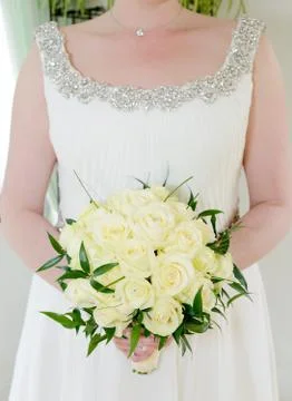 Bride holding roses Stock Photos