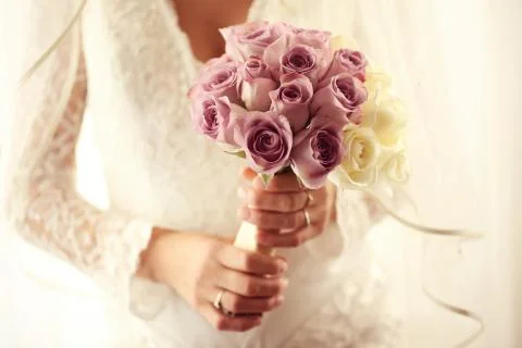 Bride holding wedding bouquet made of roses Stock Photos