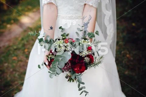 Bride holding wedding bouquet Stock Photos