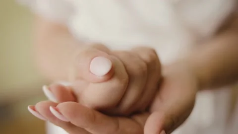 The bride holds a gold ring in her hand. The woman clenched her fist and shows Stock Footage 148348321