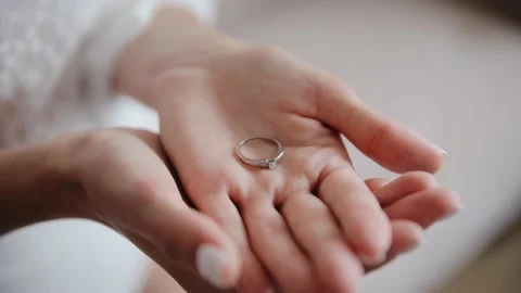 The bride holds a gold ring in her hand, is palm. Close up shot from steadicam Stock Footage 234917491