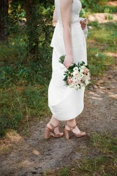 Bride holds a wedding bouquet in her hands Stock Photos