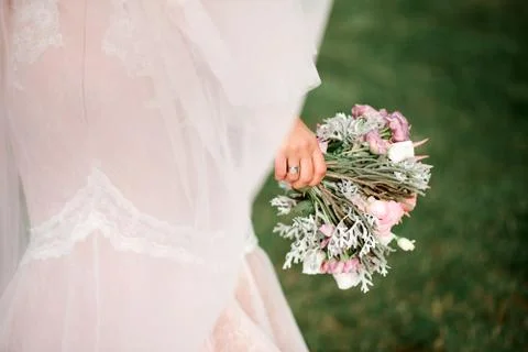 Bride holds a wedding bouquet in her hands Stock Photos