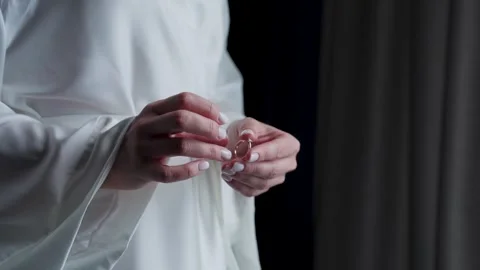 The bride holds a wedding ring in her hands Stock Footage 329094244