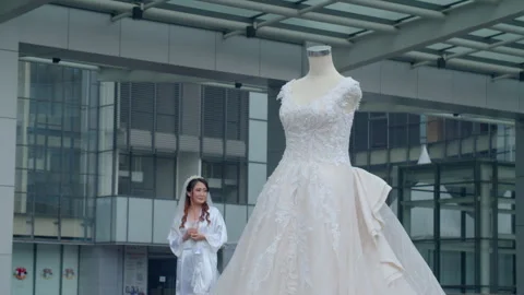 Bride Interacting With White Lace Wedding Dress On Mannequin Stock Footage 333374689
