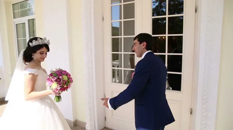 Bride invites the bride to enter the house Stock Footage 68905153