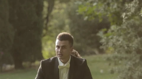 Bride jumping on the back of the groom and laughs Stock Footage 47808411