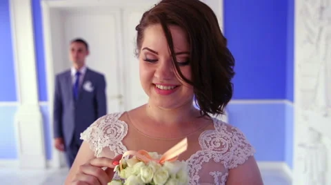 Bride laughs and sniffs bouquet Stock Footage 67980915